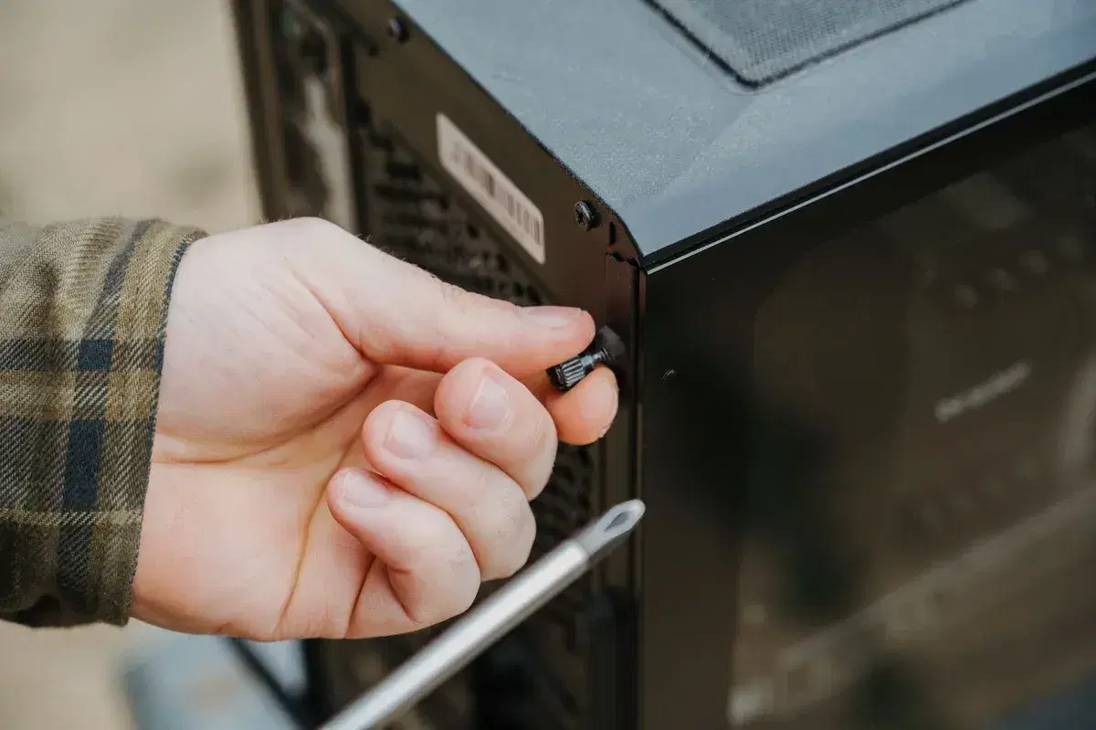 Technician performing maintenance on a desktop PC